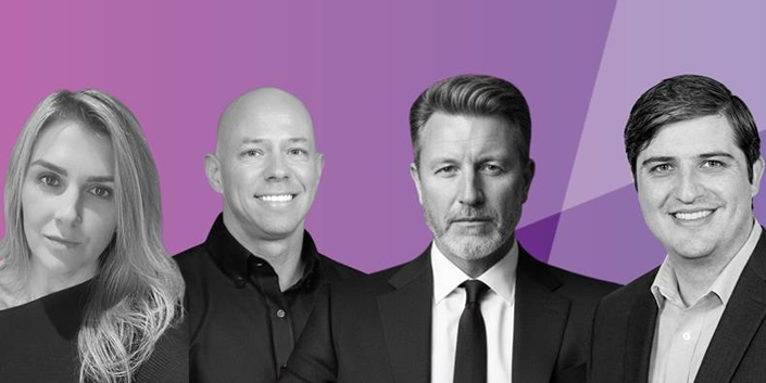 Four people, three men and one woman, pose in front of a purple geometric background. The image is partly black and white, with the background in shades of purple.