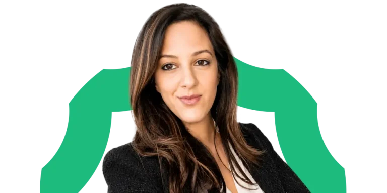 A woman with long brown hair, wearing a black blazer and white top, smiles confidently at the camera. A green graphic element curves around her against a white background.
