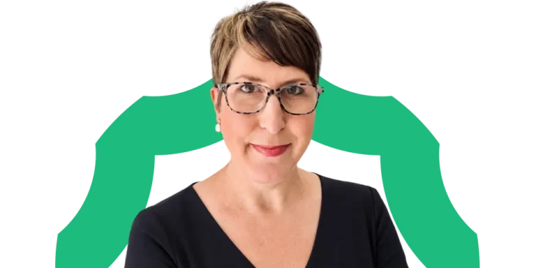 A person with short brown hair, glasses, and a black top stands in front of a white background with a green abstract shape behind them.
