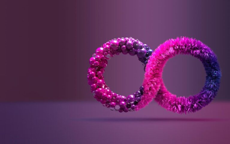 Two interlocking rings stand on a purple surface. One ring is shiny with reflective spheres, and the other is covered in soft, furry pink and blue textures. The background is a smooth gradient of purple tones.
