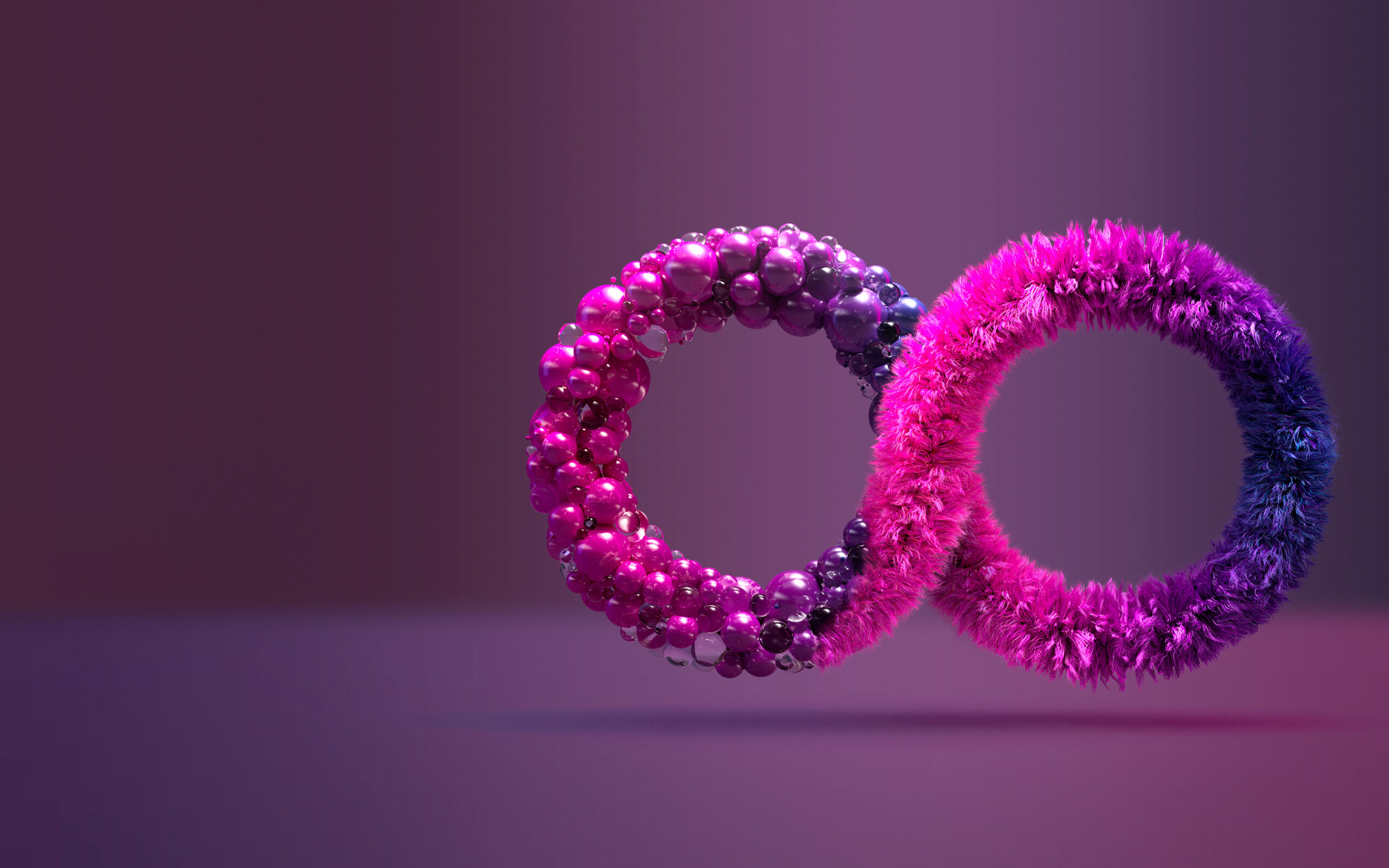 Two intertwined rings, one covered in shiny pink and purple beads, the other wrapped in soft, fuzzy pink and blue material, set against a smooth purple gradient background.