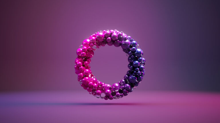 A 3D ring made of small, glossy spheres in pink and purple hues floats against a softly blurred, colourful gradient background.