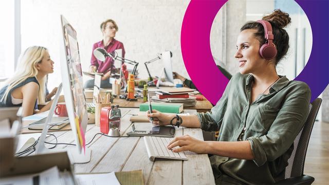 A woman wearing headphones works at a computer in a modern office with three colleagues nearby. The desk is cluttered with office supplies, and a colourful circle design is overlaid in the background.