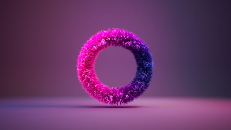 A fluffy, textured ring floats in mid-air, blending vibrant pink and purple hues against a softly blurred, gradient background.