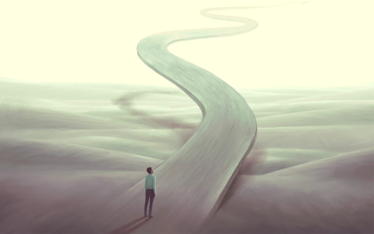 A person stands at the start of a long, winding road that disappears into a bright, hazy distance across an empty, surreal landscape.