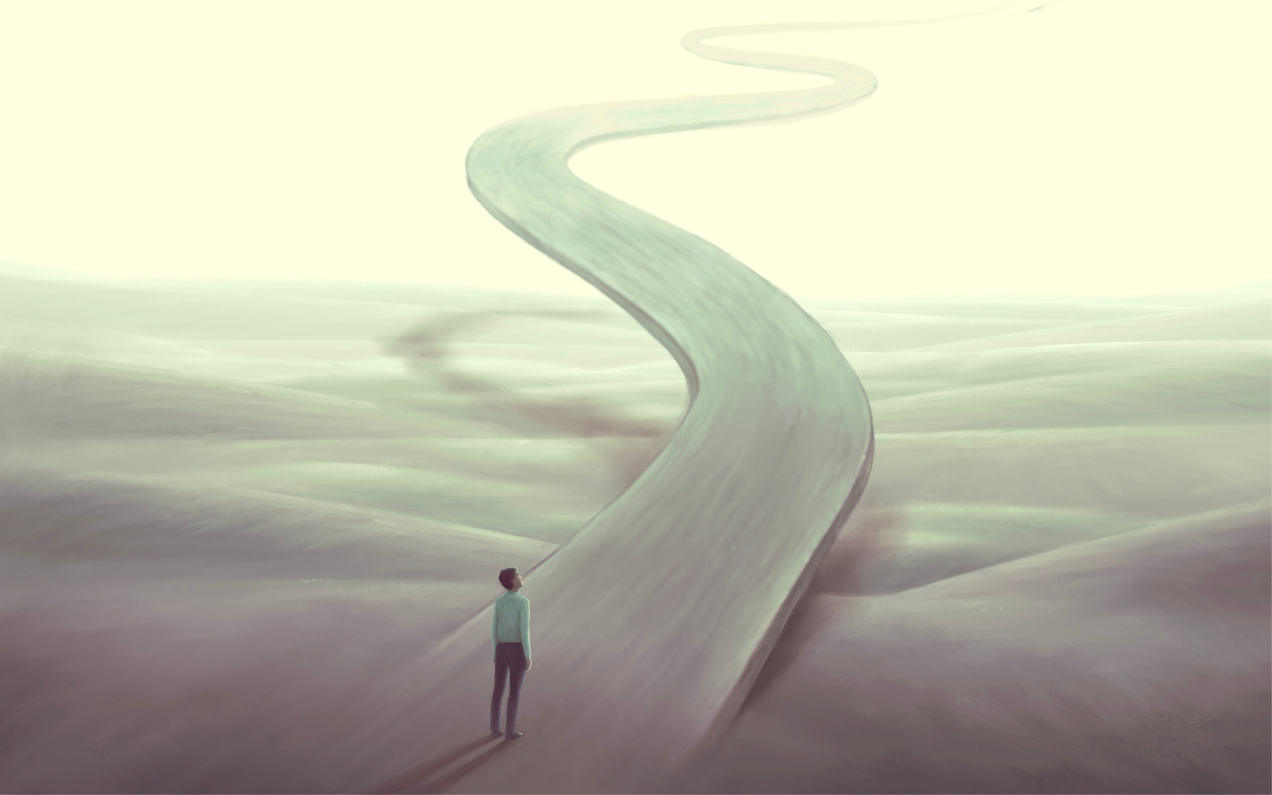 A person stands at the start of a long, winding road that disappears into a bright, hazy distance across an empty, surreal landscape.