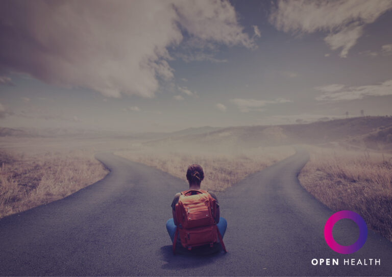 A person with a red rucksack sits at a fork in the road in a rural landscape, facing away. The Open Health logo is in the bottom right corner.