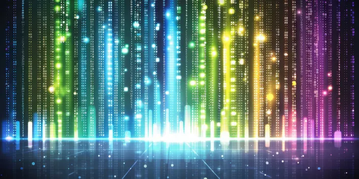 Colourful vertical lines of binary code glow against a dark background, resembling a digital rain or futuristic data stream. The image evokes a sense of technology and virtual reality.
