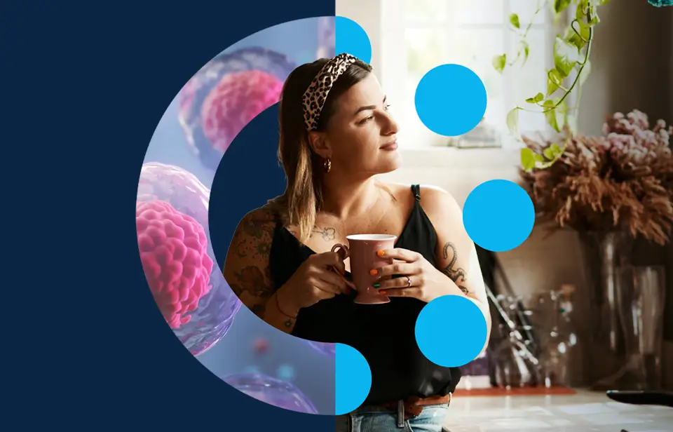 A woman with tattoos holds a mug and looks out of a window. The left half of the image features scientific graphics of cells and blue dots, merging into her kitchen setting on the right.