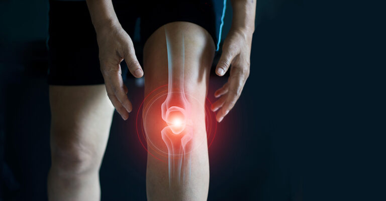 A person holding their knee, with a red glow and illustration highlighting joint pain or injury in the knee area, against a dark background.