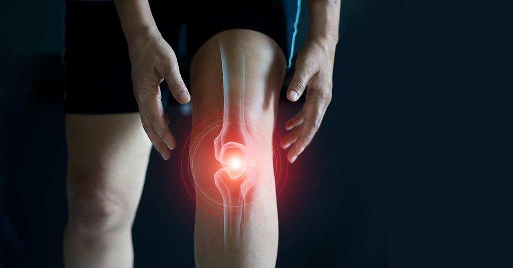 A person holding their knee, with a red glow and illustration highlighting joint pain or injury in the knee area, against a dark background.