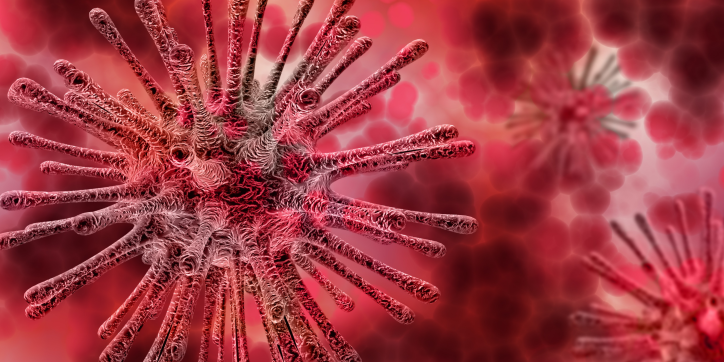 Close-up illustration of a red, spiky virus particle with a blurred background featuring similar virus shapes in varying shades of red and pink.