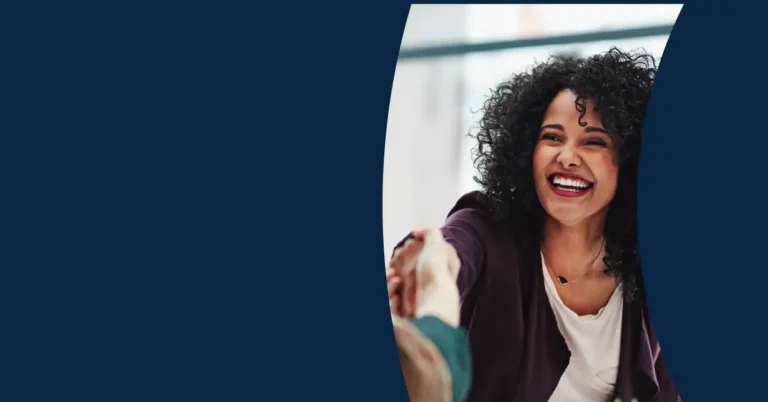 A smiling person with curly hair extends a hand for a handshake, set against a blue background with a curved cut-out framing the interaction.