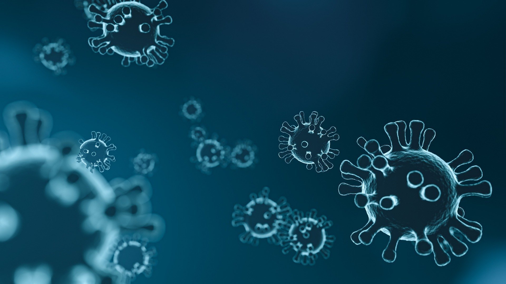 Illustration of multiple virus-like structures floating against a blue background, representing microscopic germs or viruses. The shapes resemble stylised viral particles with circular bodies and protruding spikes.